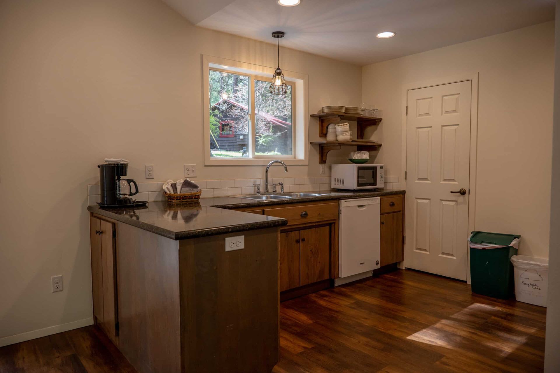 A kitchen with a sink , microwave , and dishwasher.
