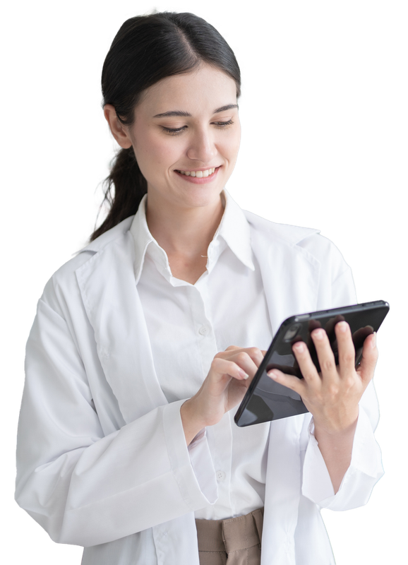 Woman in white lab coat smiles while using a tablet.