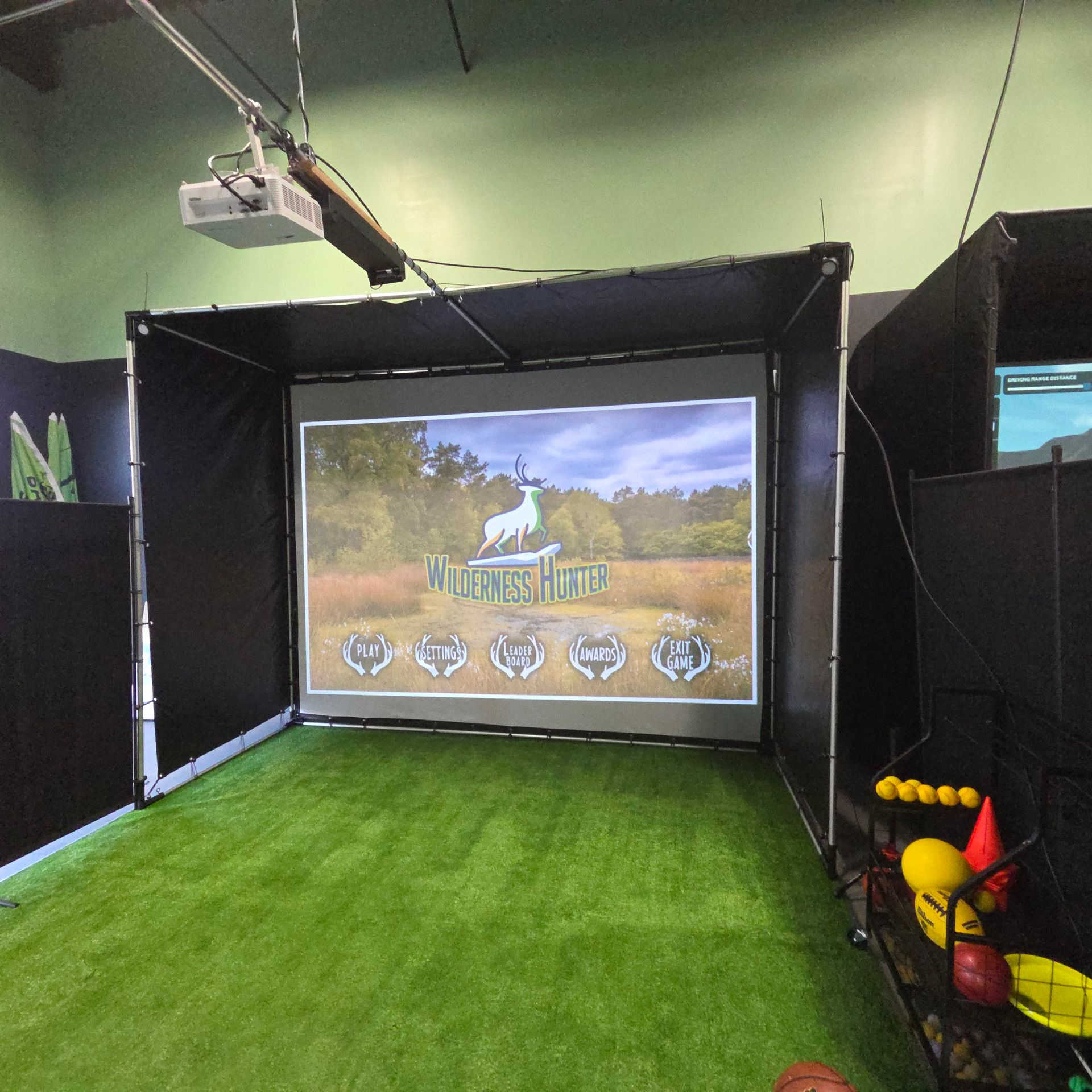 A gloved hand placing a golf ball on a tee on artificial turf.