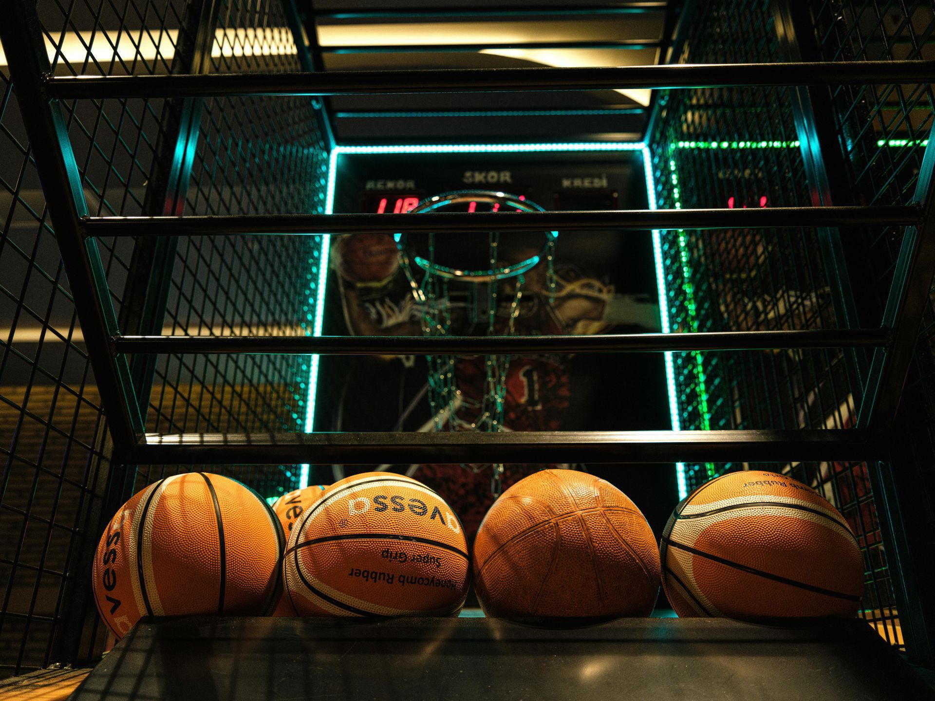 Basketball arcade game with balls, scoreboard, and hoops.