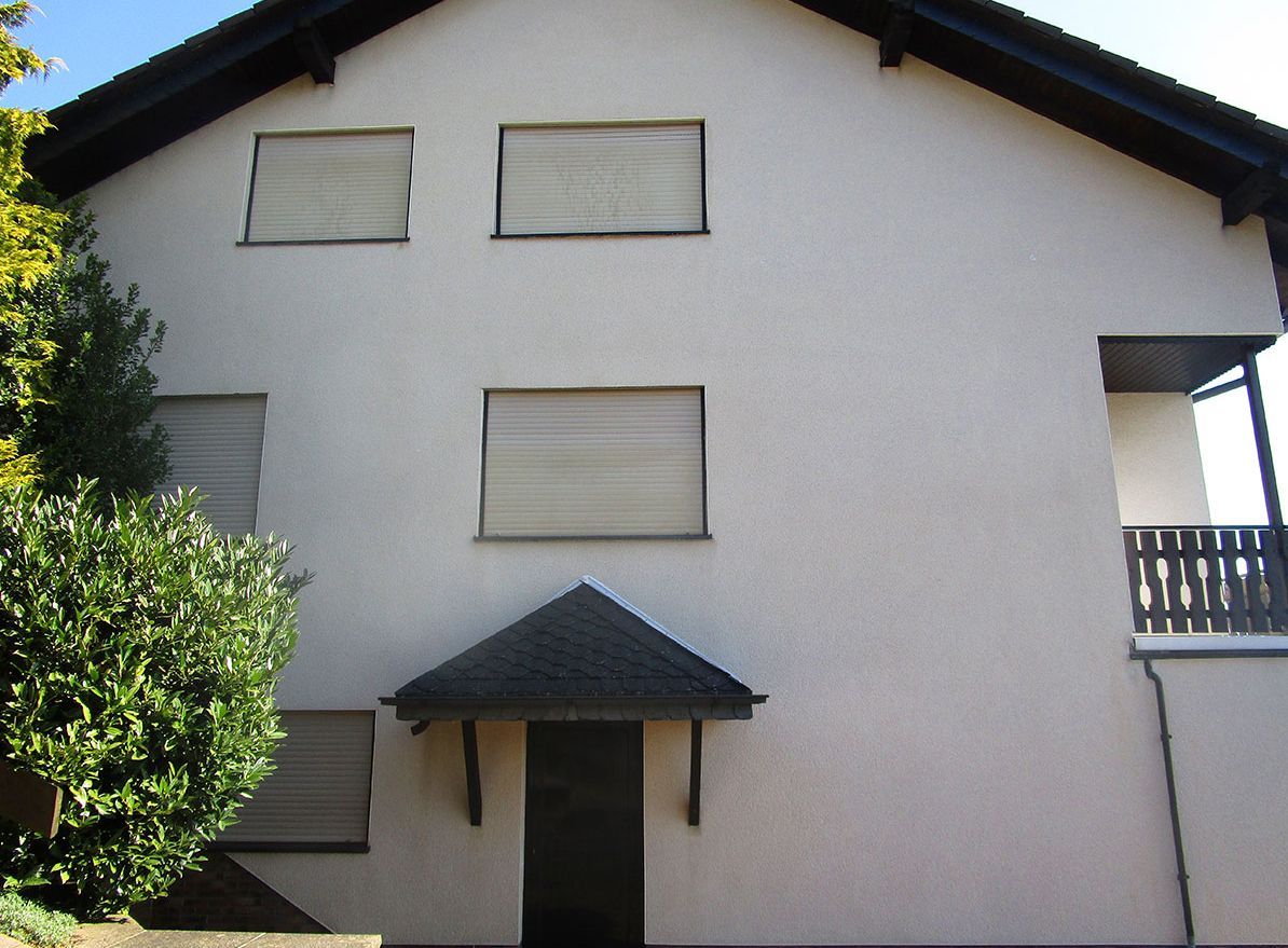 Slika prikazuje očiščeno fasado na hiši v okolici Ljubljane.