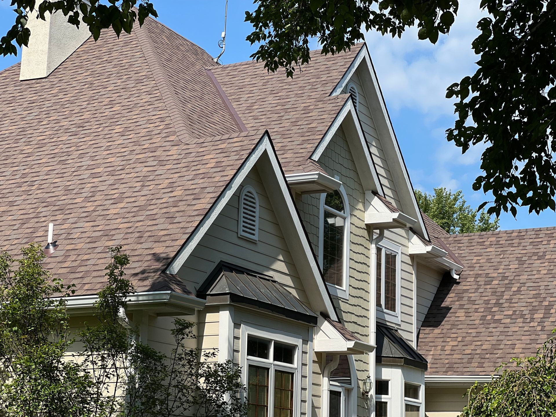 An aerial view of a house with a gray roof.