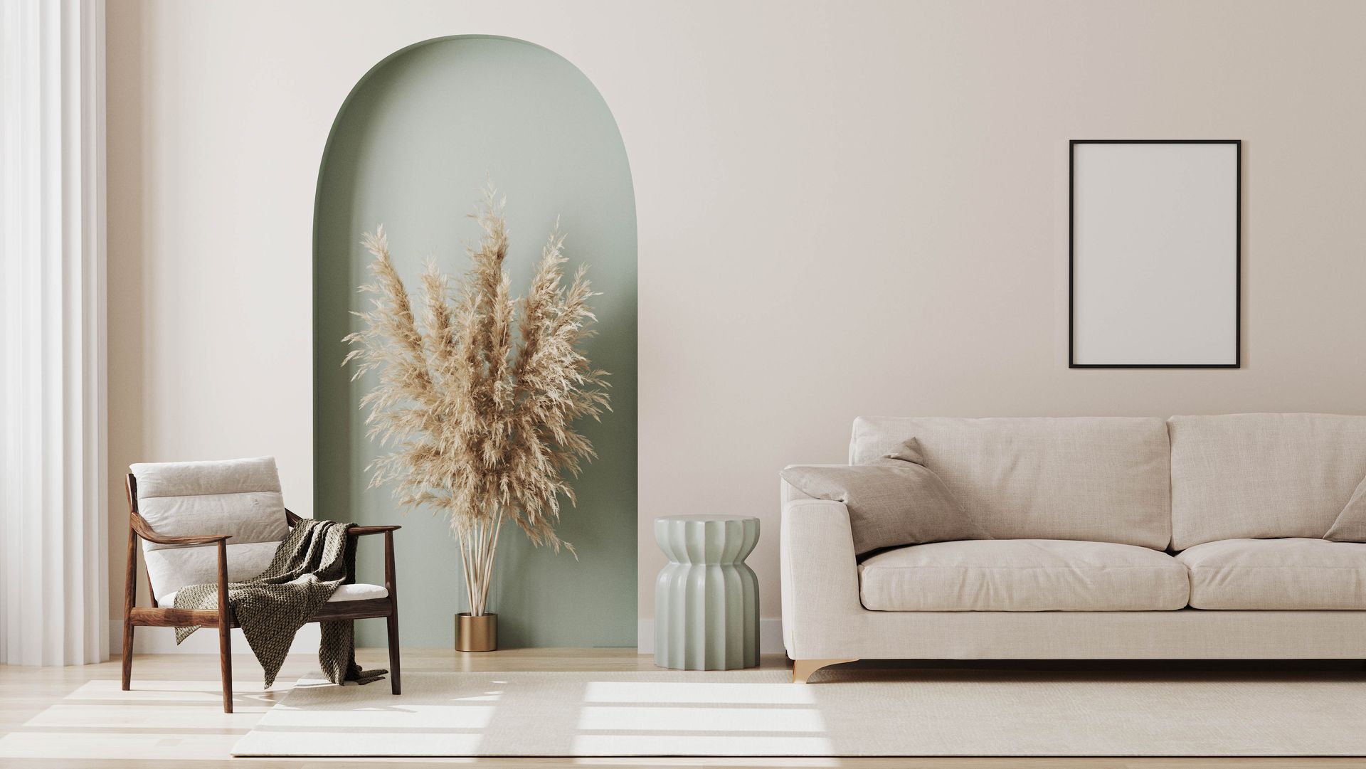 Beige living room with sofa, chair, and archway with pampas grass. Blank framed artwork.