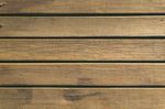 Wooden deck planks, brown with horizontal grooves.