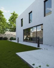 Modern house with white stucco walls, glass windows, stone patio, green lawn, and trees.