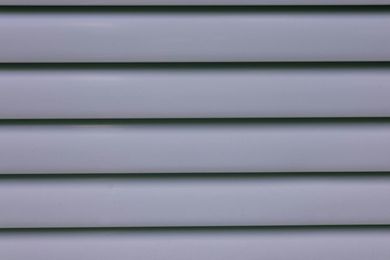 Horizontal, gray-blue, vinyl siding.