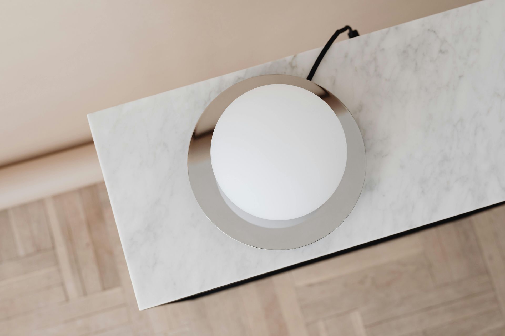 A lamp is sitting on top of a marble table.