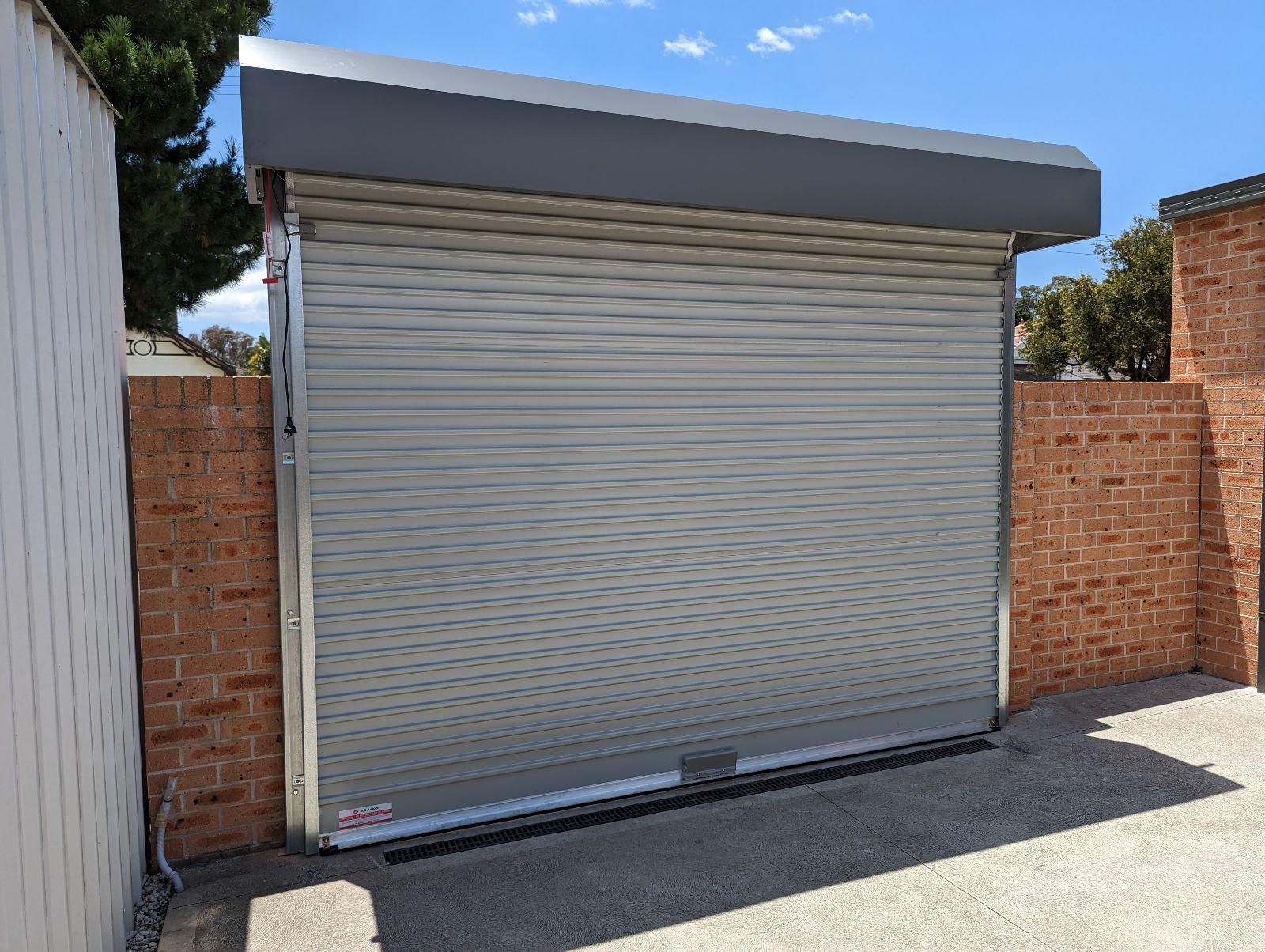 Installed Fence Line Roll-A-Door — Sydney, NSW — Ryde Garage Doors