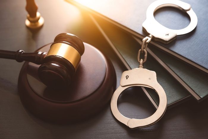 Judge’s gavel beside handcuffs on a desk, symbolizing criminal justice and arrest Judge’s gavel beside handcuffs on a desk, symbolizing criminal justice and arrest