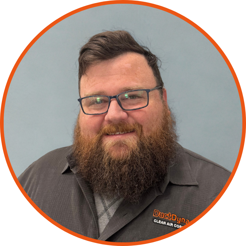 A man in a suit and tie is smiling for the camera.