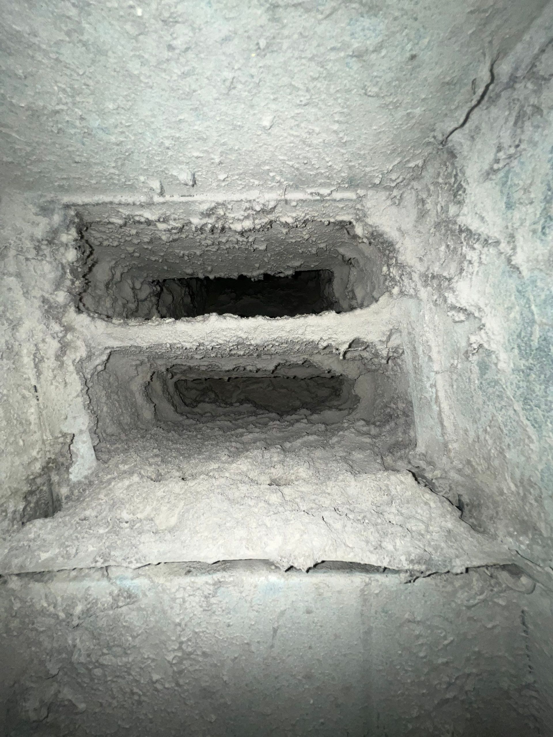 A black and white photo of a hole in a wall.