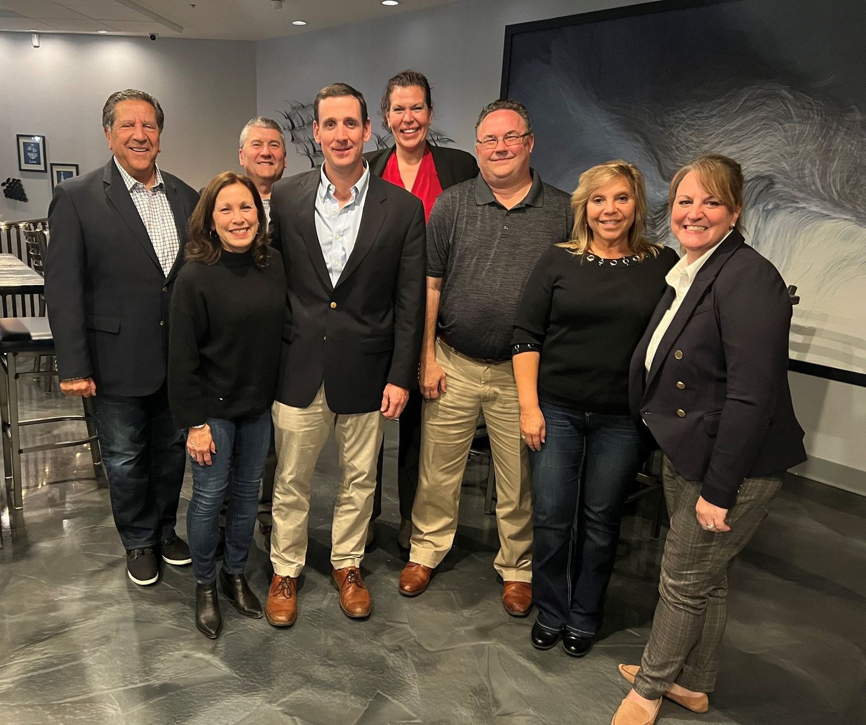 A group of people are posing for a picture in a room.