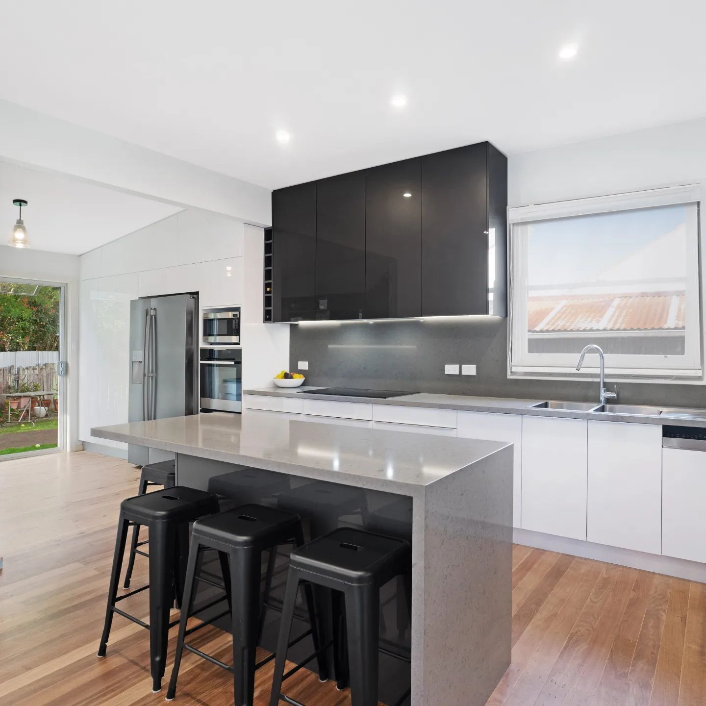 Modern Kitchen with Grey Cupboards and Timber Floors — Garry Jeans Kitchens In Newcastle, NSW