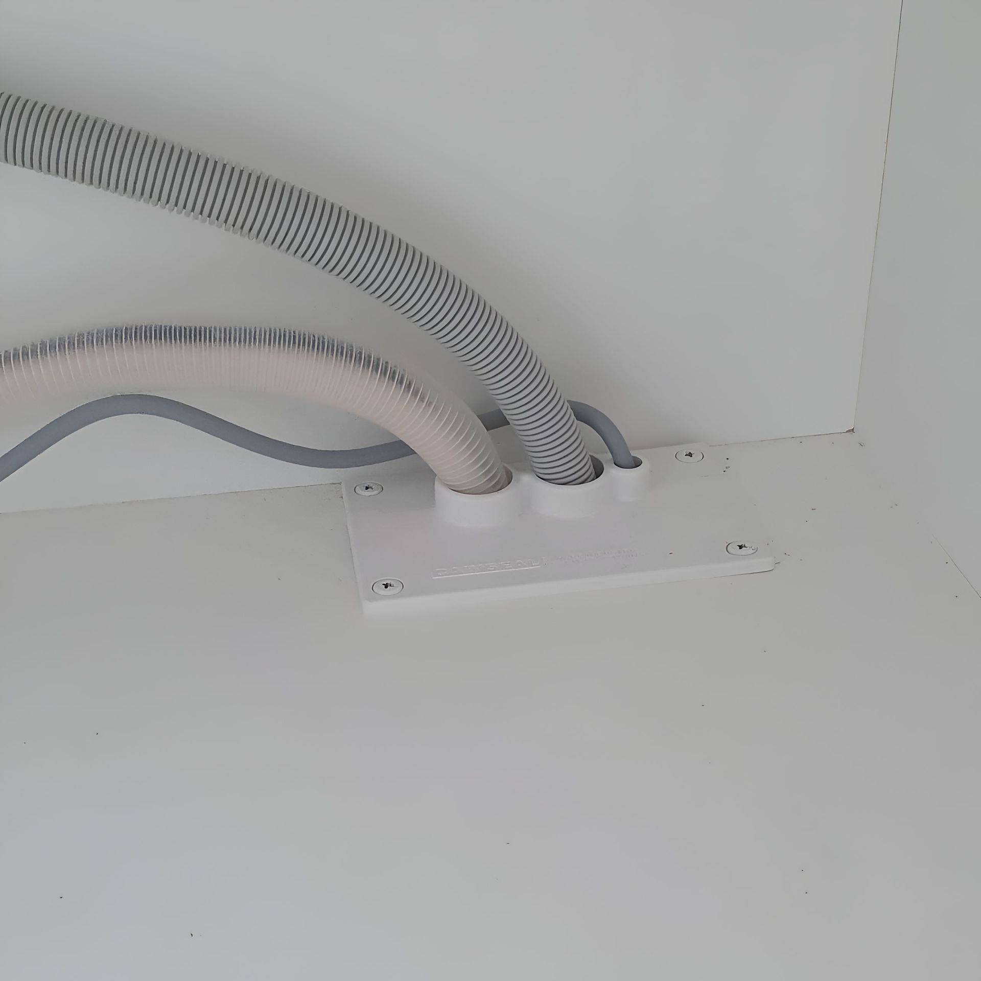 A Couple of Hose Connected to a White Wall — Garry Jeans Kitchens In Lake Macquarie, NSW