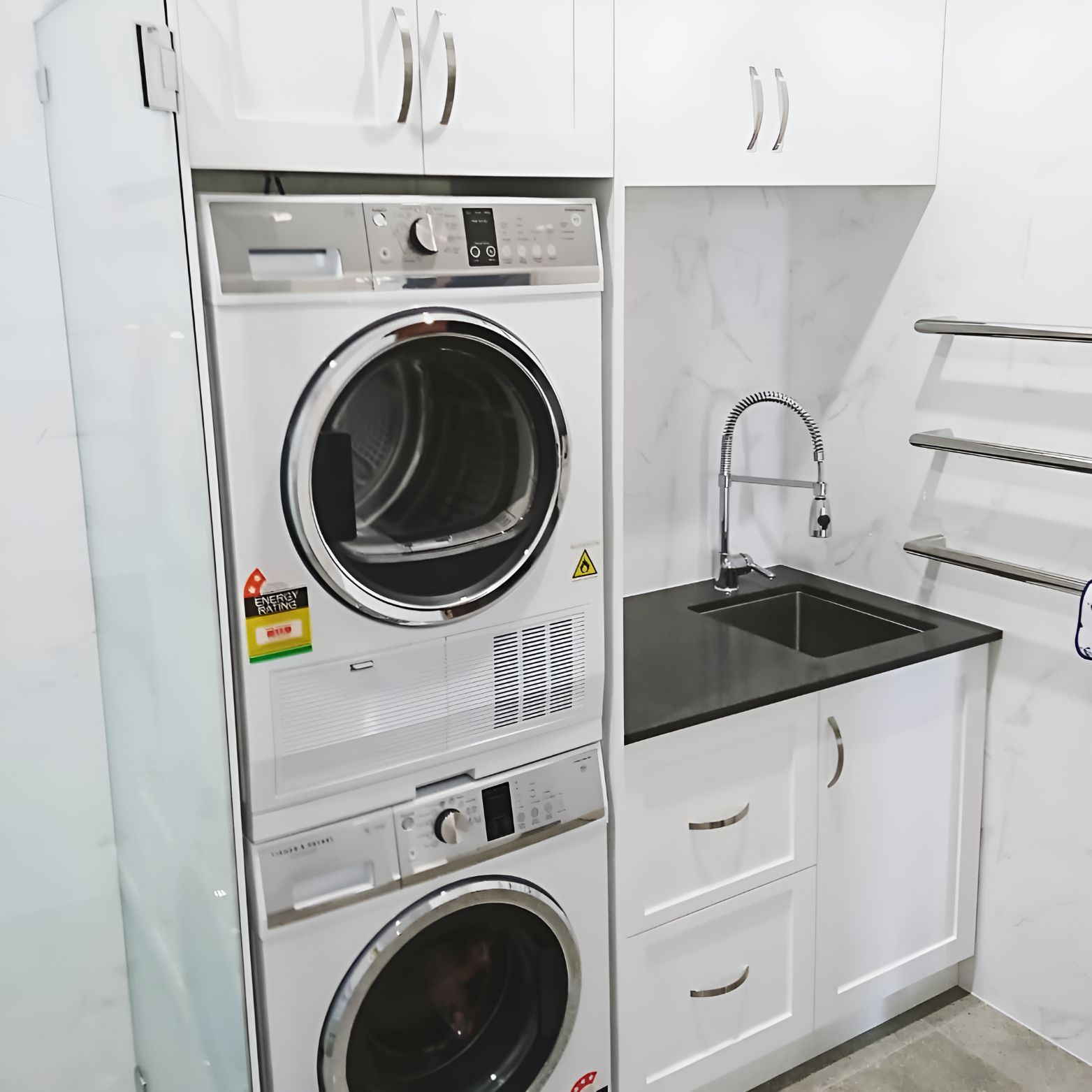 A Laundry Room With a Washer and Dryer Stacked on Top of Each Other — Garry Jeans Kitchens In Newcastle, NSW