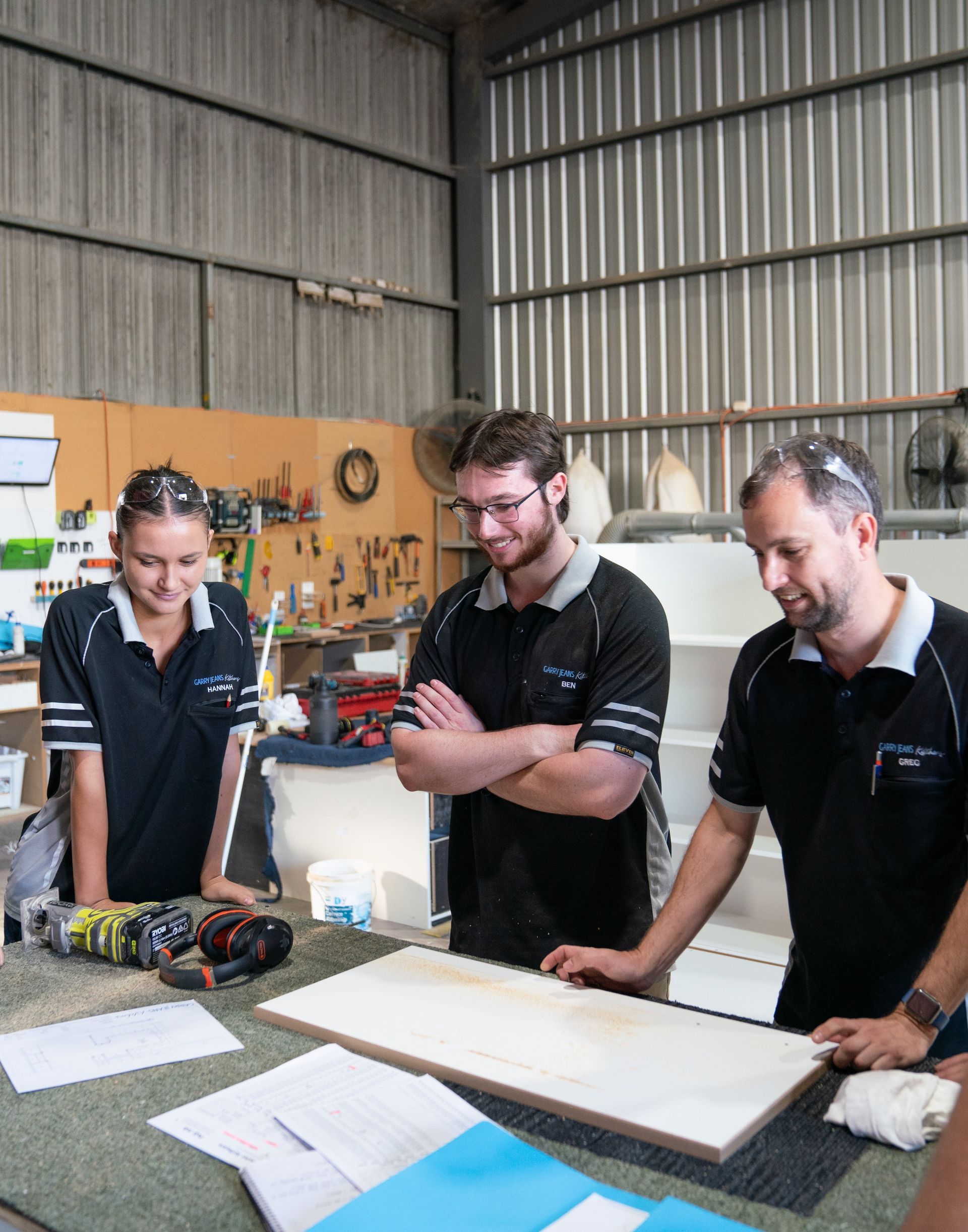 Two Men Are Standing Next To Each Other In A Room — Garry Jeans Kitchens In Cardiff, NSW