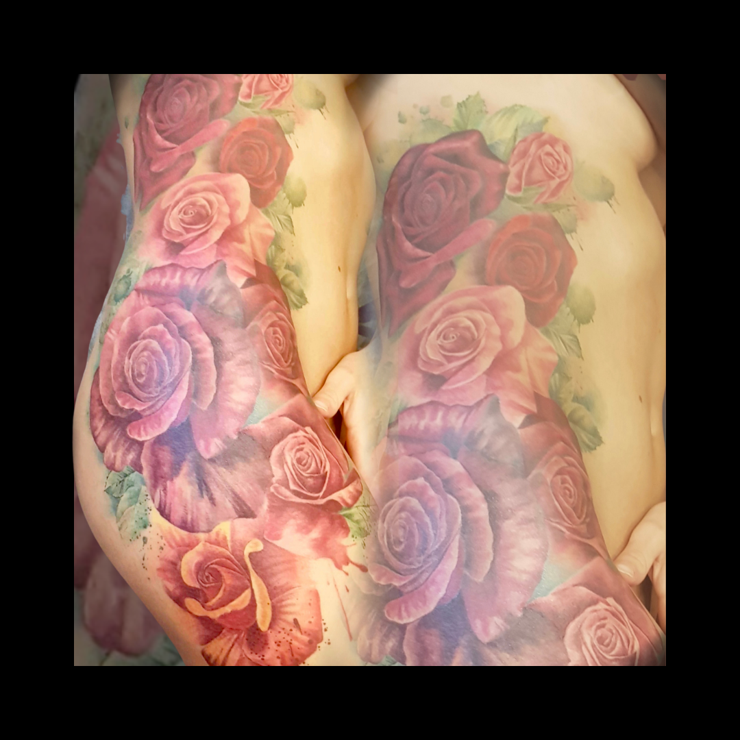 side tattoo with pink and red roses