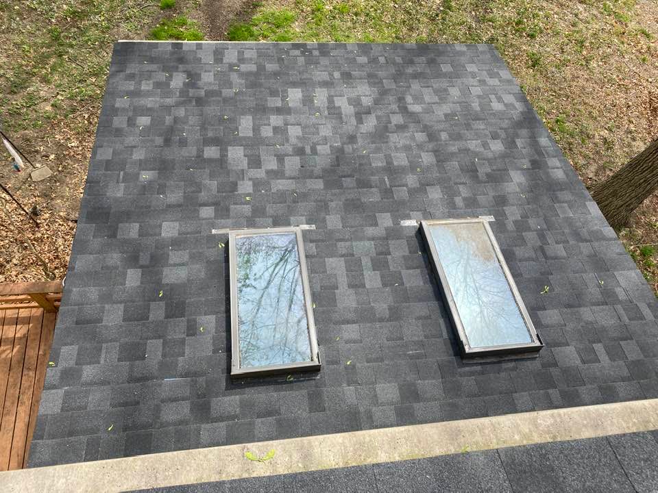 There are two skylights on the roof of a house.