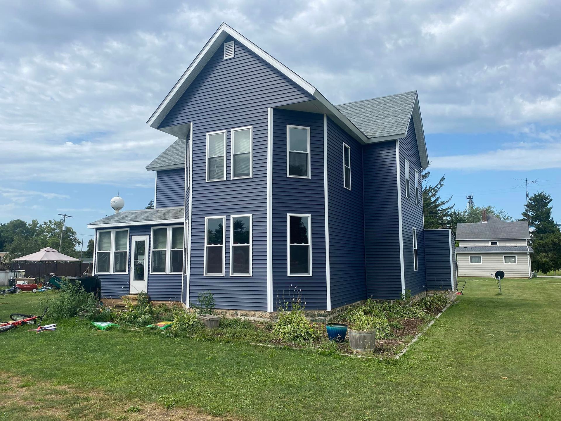 A large blue house with a lot of windows