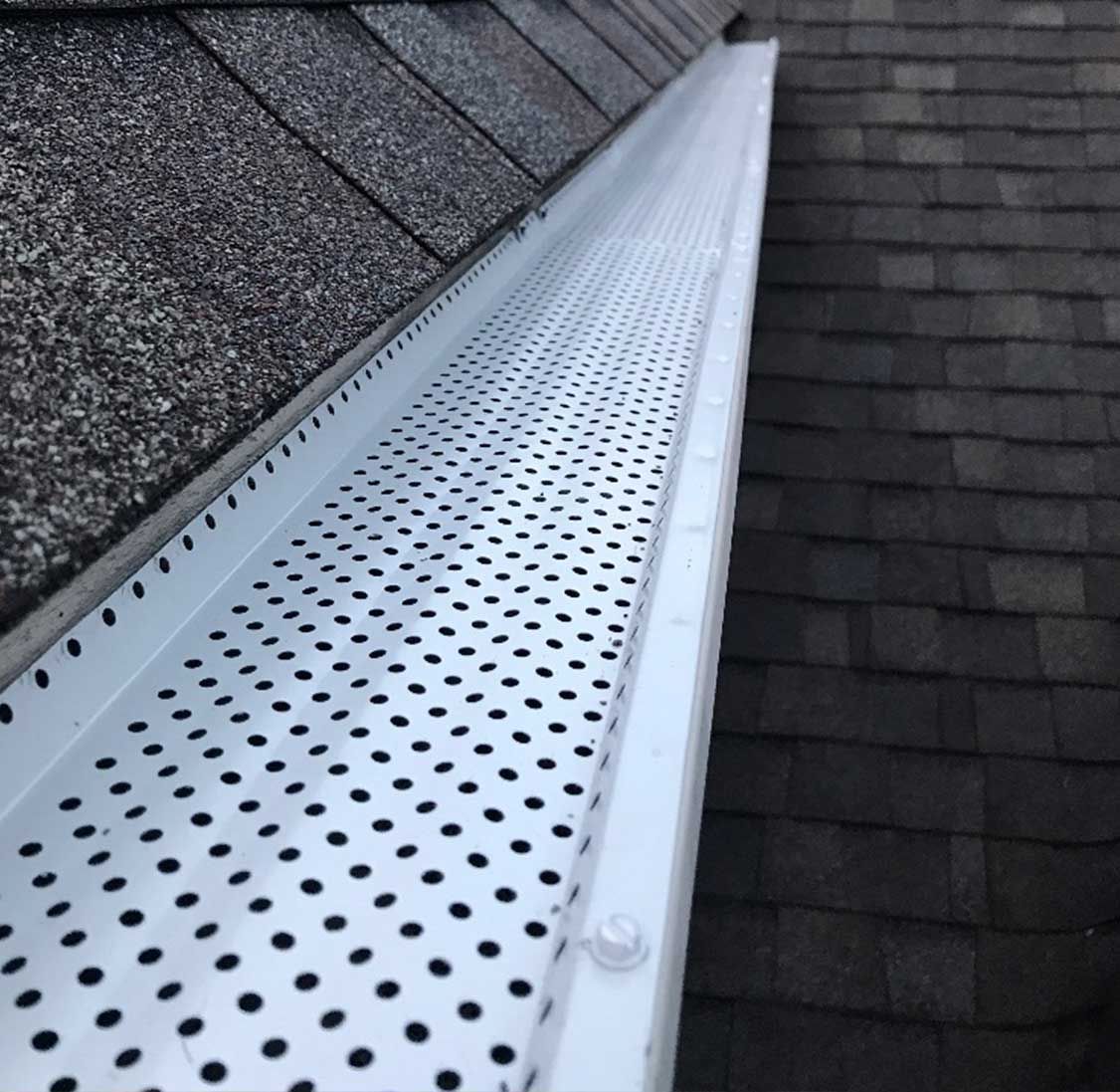 A house with a gutter on the side of it