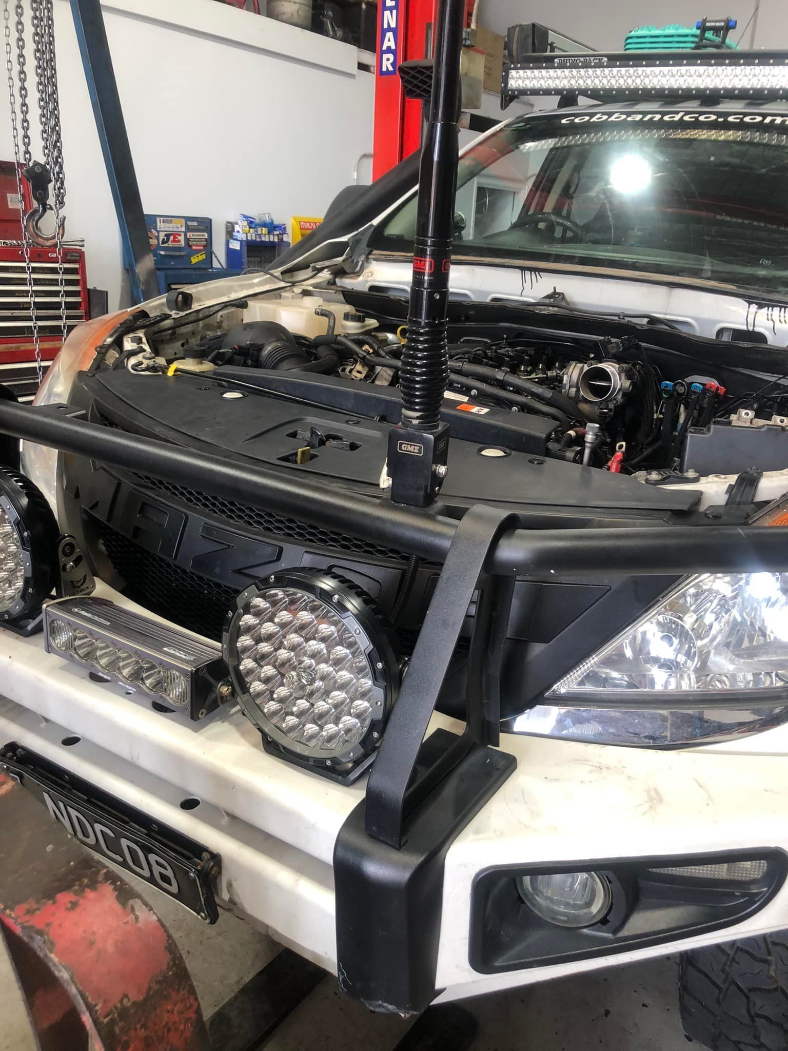 White Off-road Vehicle With Lights and Bumper in a Workshop, Hood Open for Work — Diesel Engine Rebuilding Australia in Gold Coast, QLD