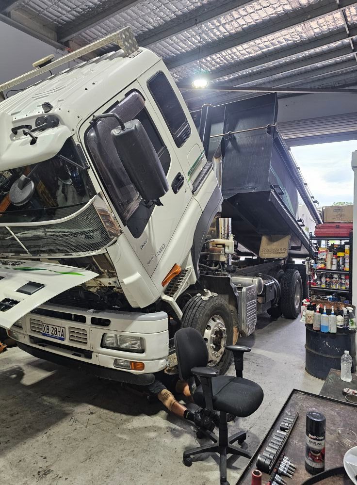 White Dump Truck Being Repaired In A Shop — Experienced Mechanics on the Gold Coast, QLD