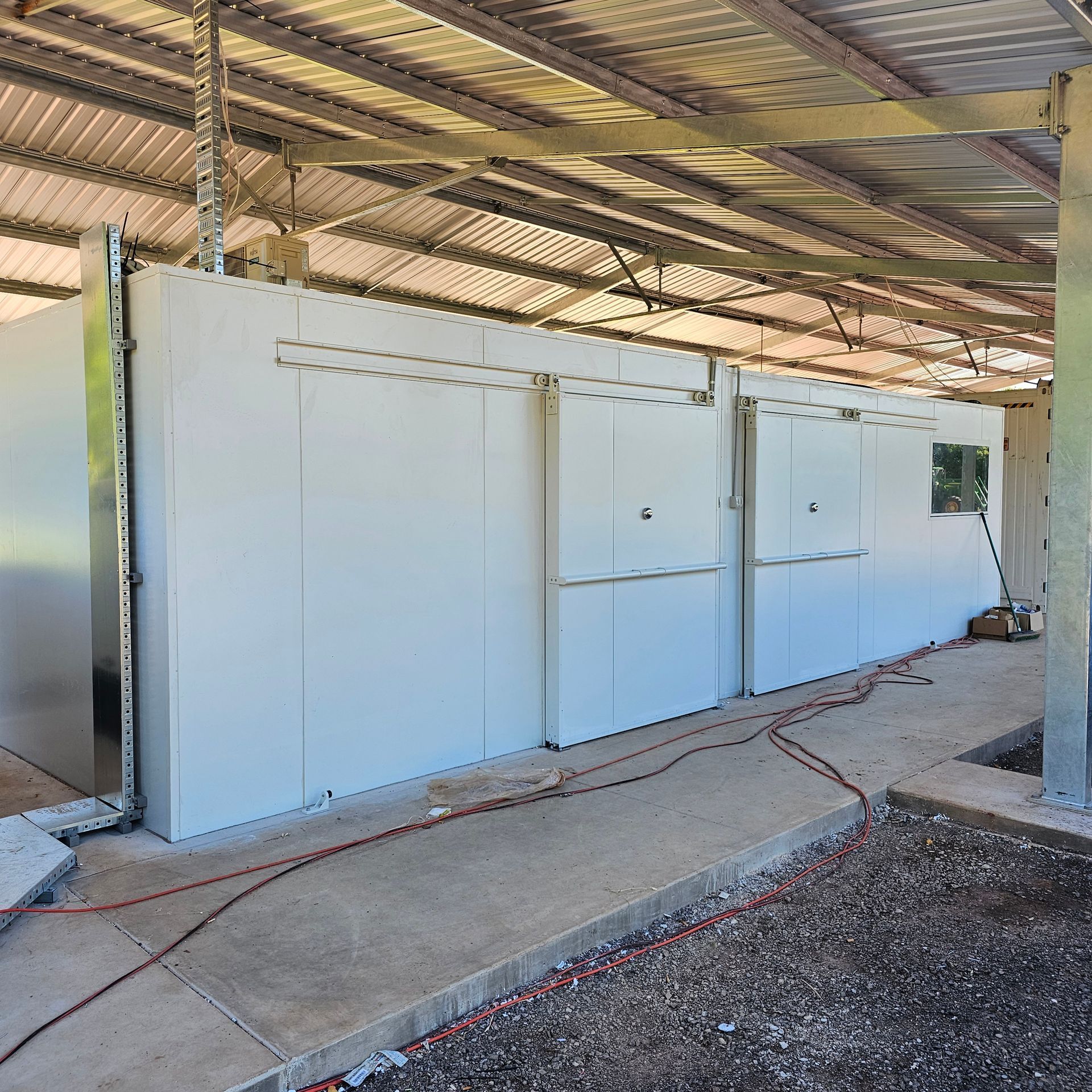 A Building With White Walls and a Metal Roof — Refrigeration & Air Conditioning in Katherine East, NT