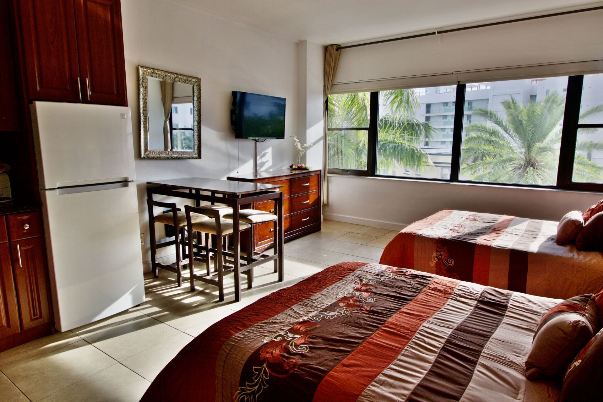 A hotel room with two beds and a refrigerator