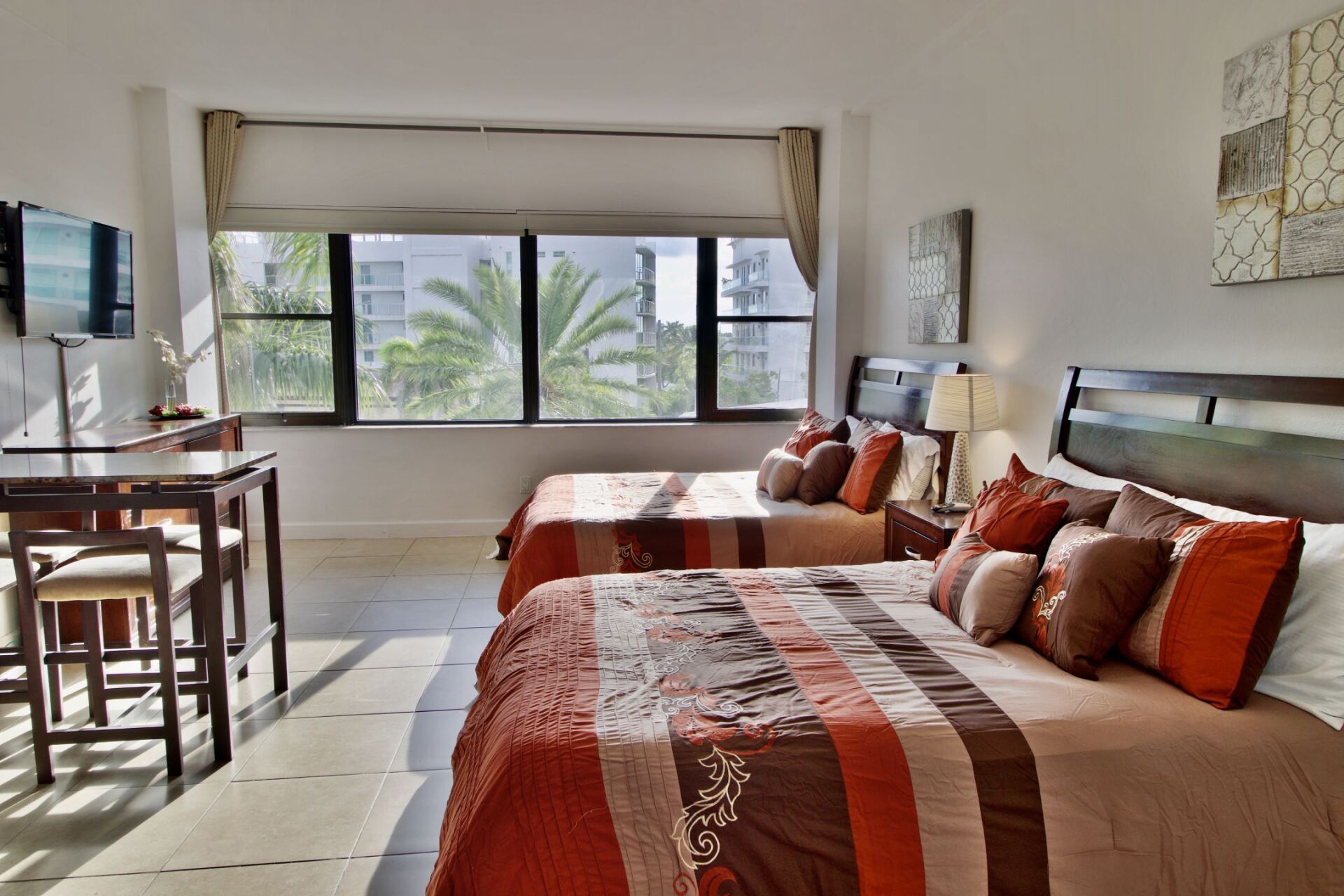 A hotel room with two beds and a table