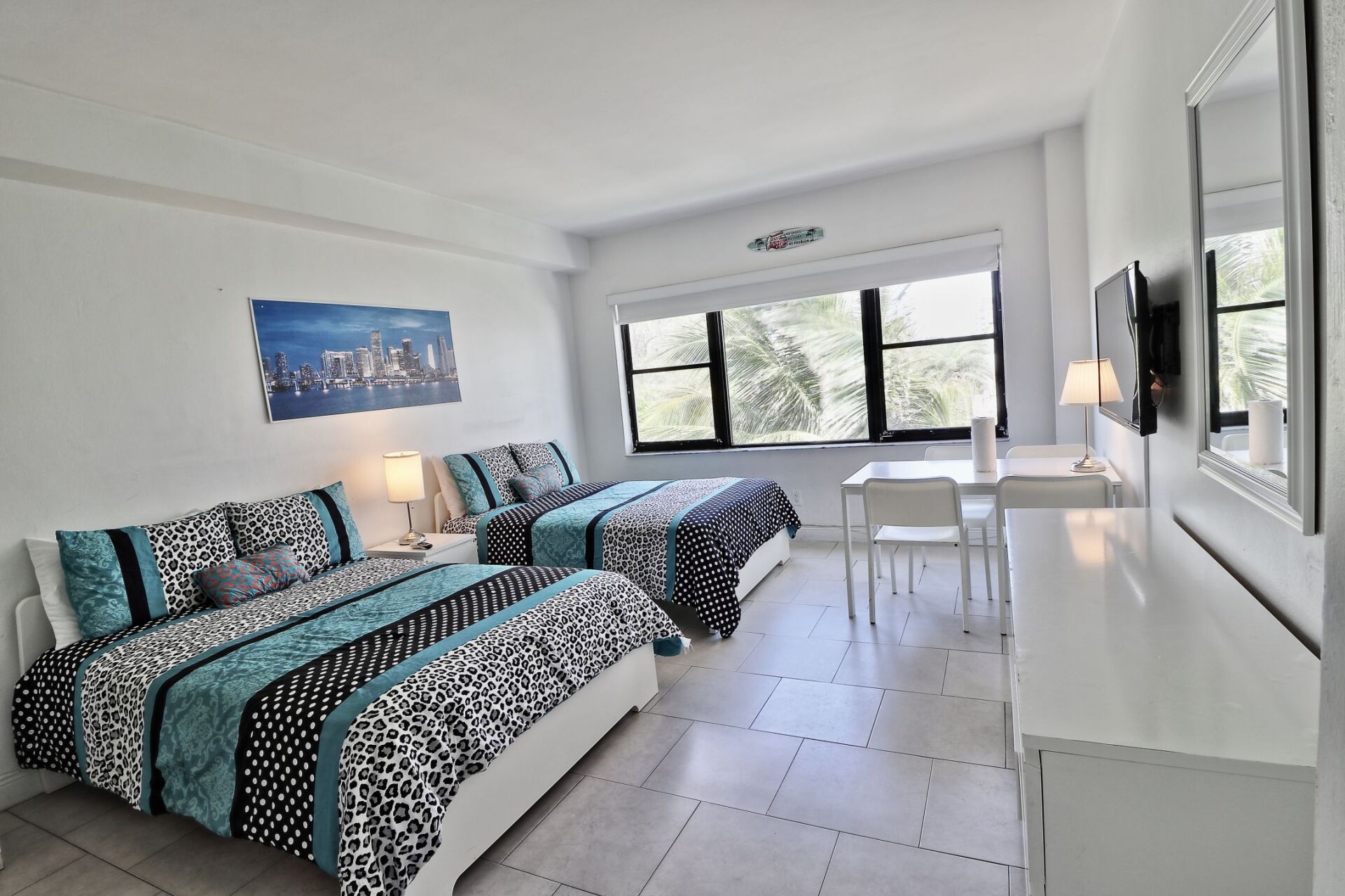 A hotel room with two beds and a table
