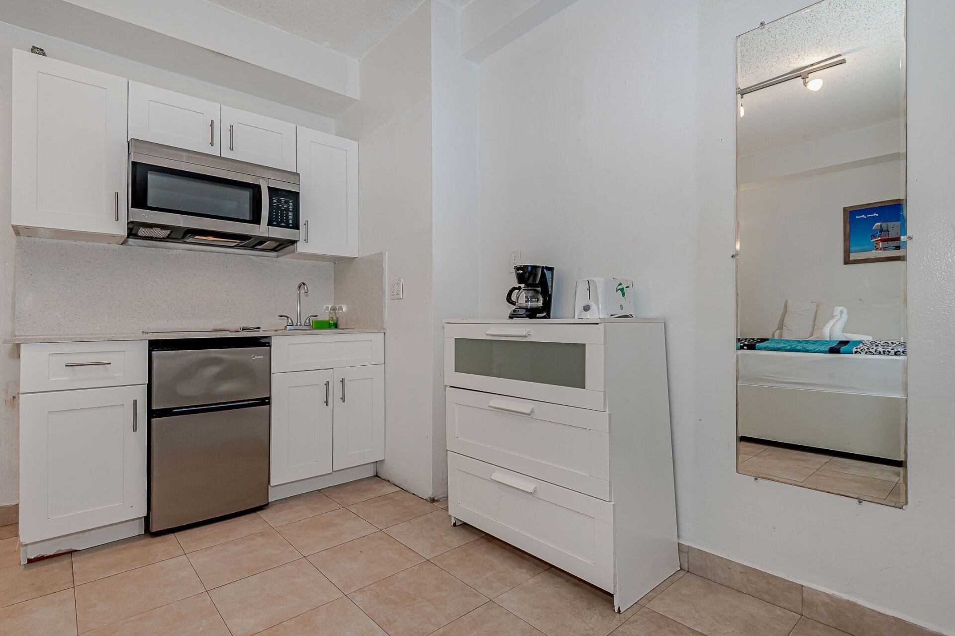 A kitchen with stainless steel appliances and white cabinets