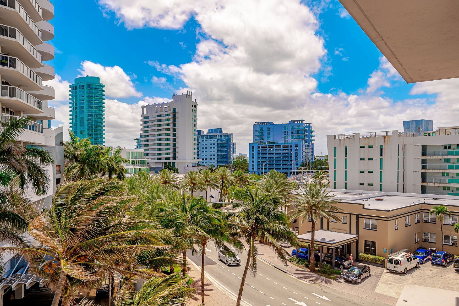 An aerial view of a city with palm trees and buildings