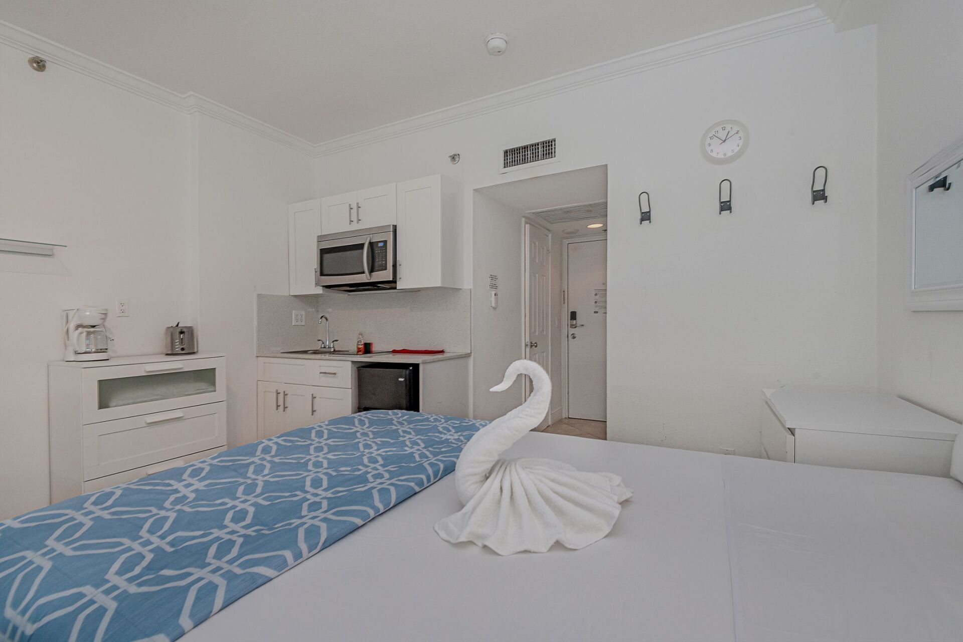 There is a swan on the bed in the room.