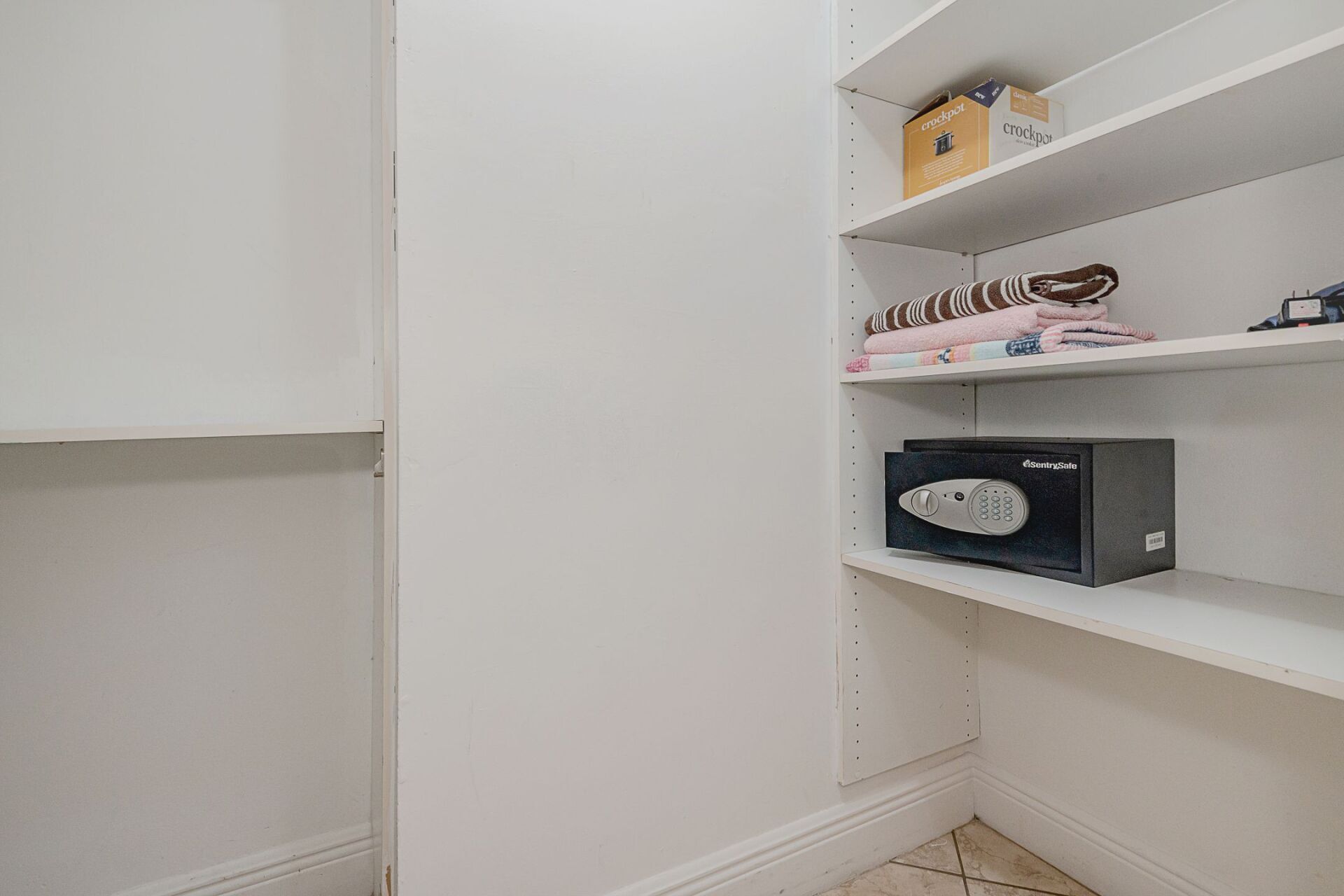 There is a safe on the shelf in the closet.