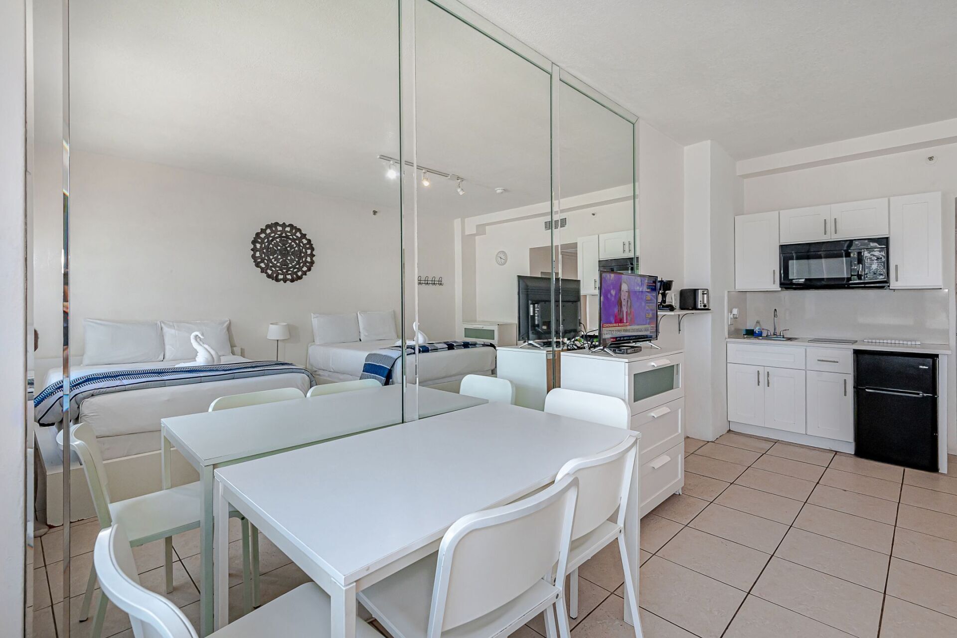 There is a table and chairs in the middle of the room.