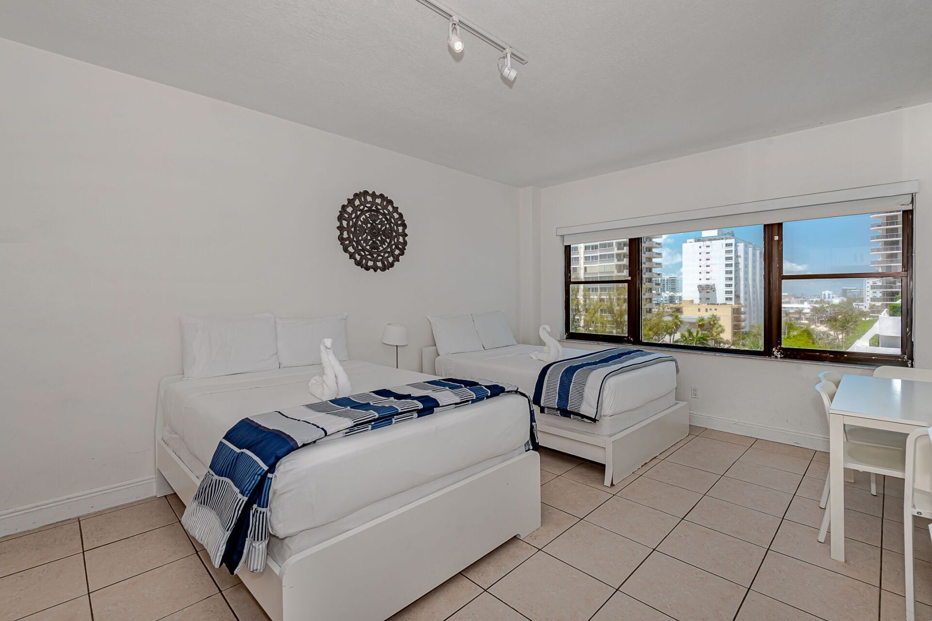 A hotel room with two beds and a desk