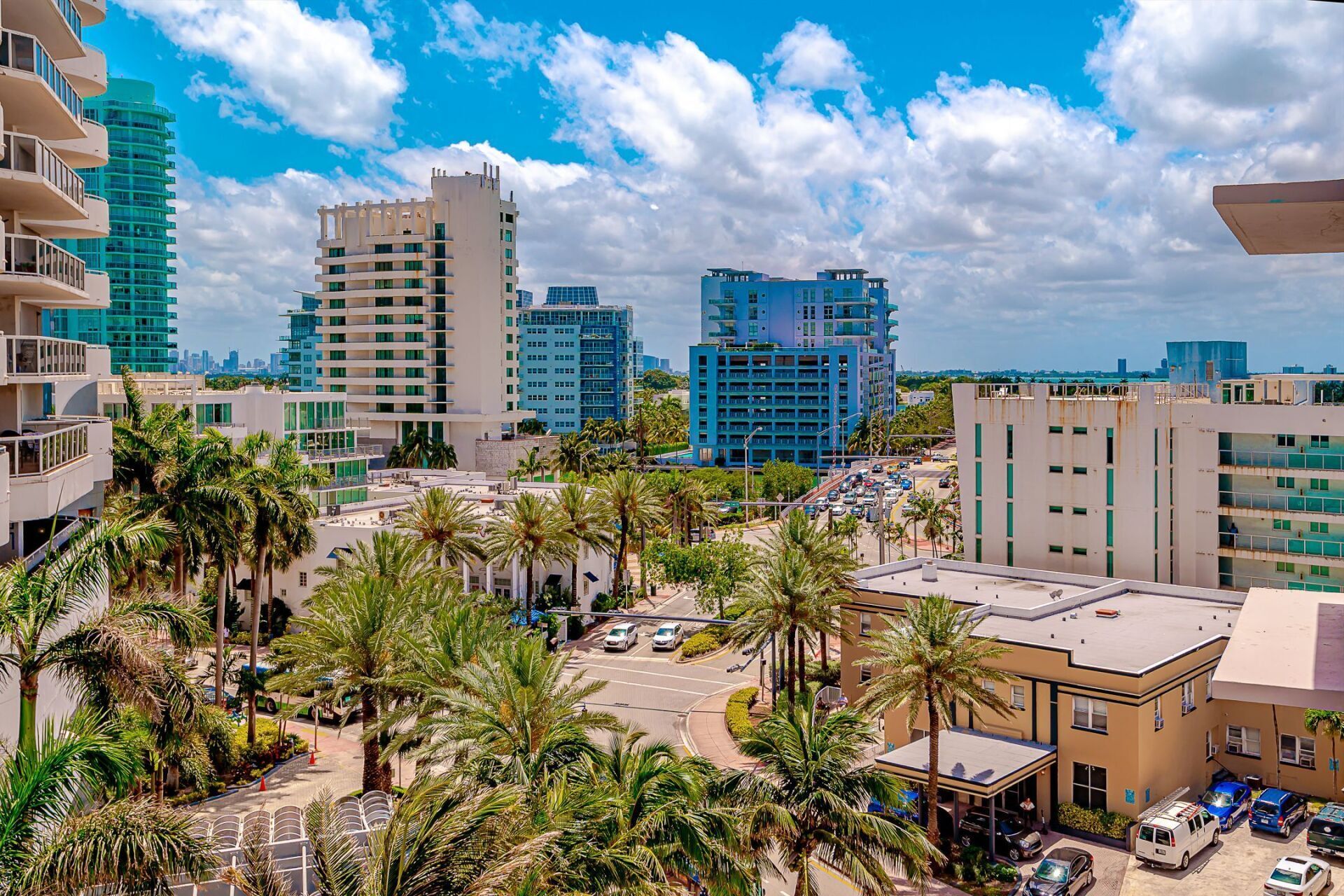 An aerial view of a city with lots of buildings and palm trees.
