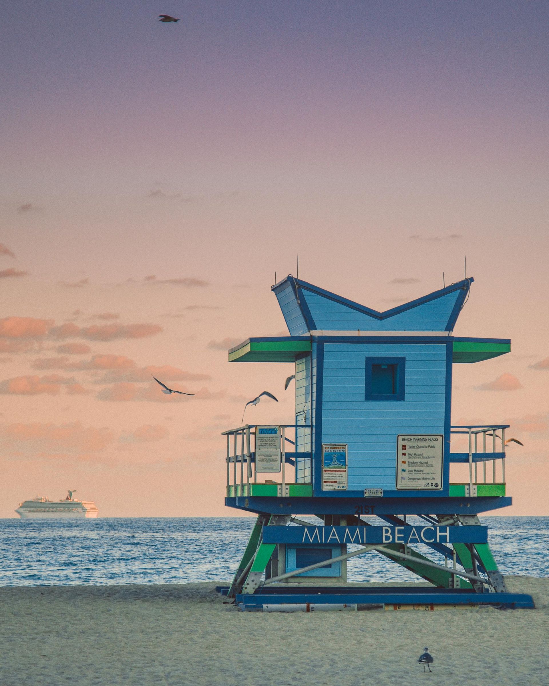 A blue and green lifeguard tower on miami beach