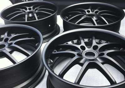 Quatre roues noires sont posées les unes sur les autres sur une table.