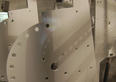 A bunch of white pieces of metal with holes in them.