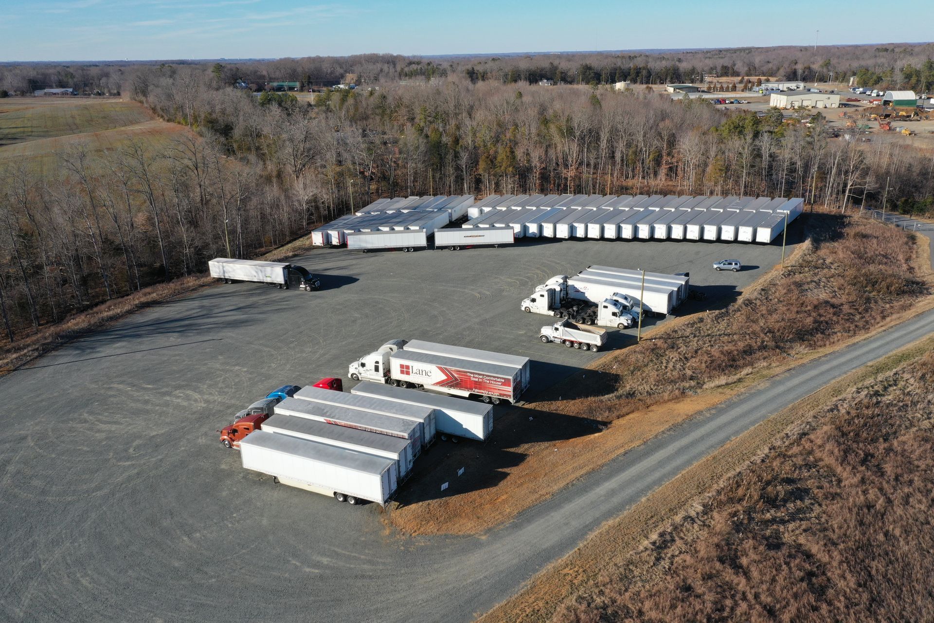 An aerial view of a warehouse with trucks parked in a lot.