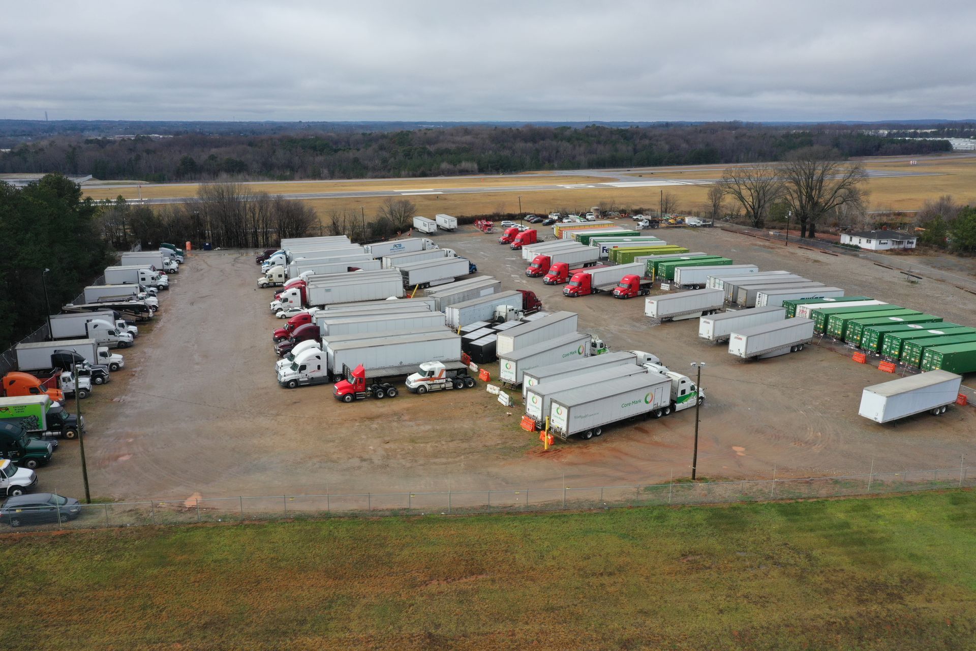 An aerial view of a large parking lot filled with trucks and trailers.