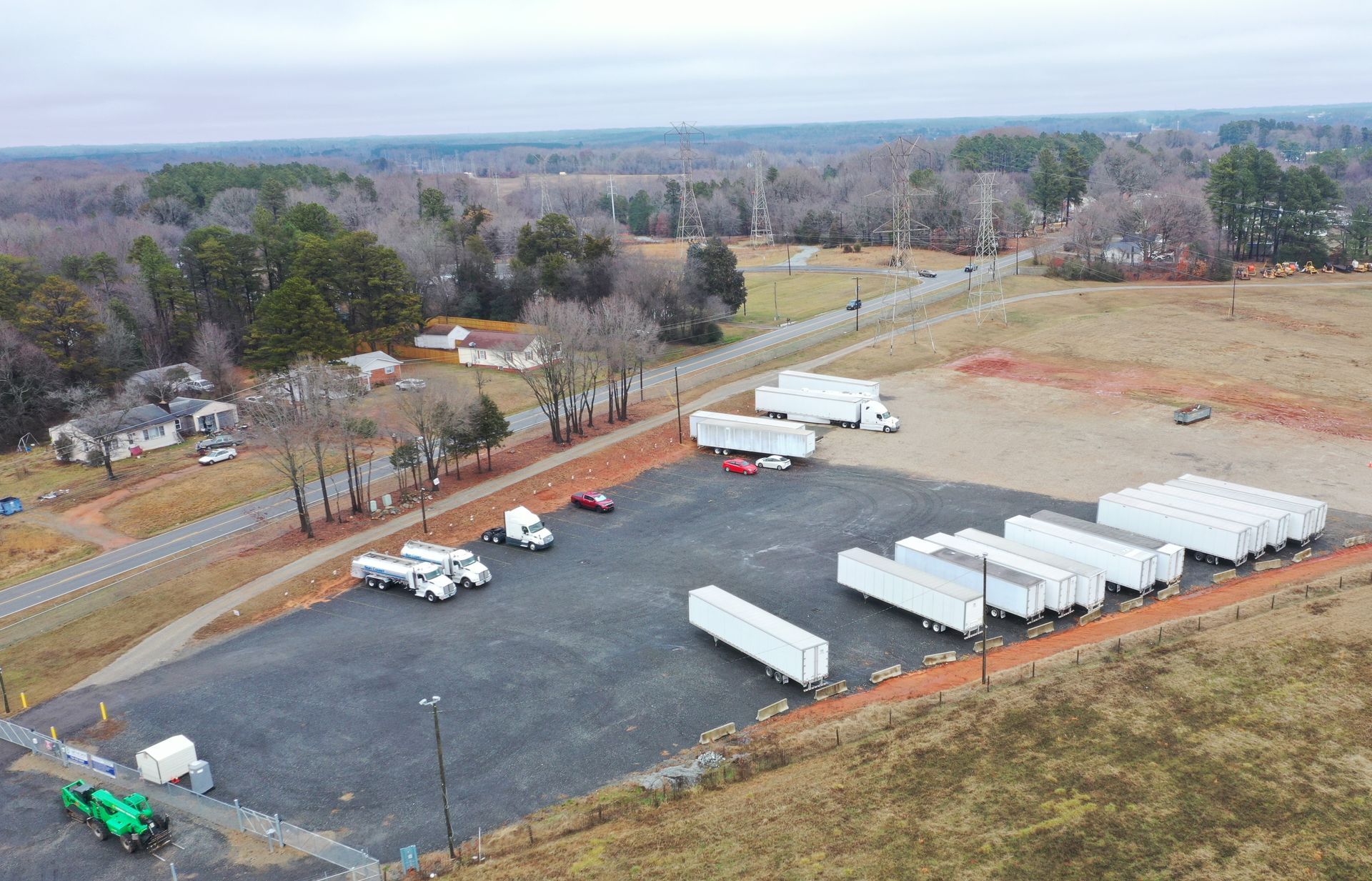 An aerial view of a parking lot filled with trucks and trailers.