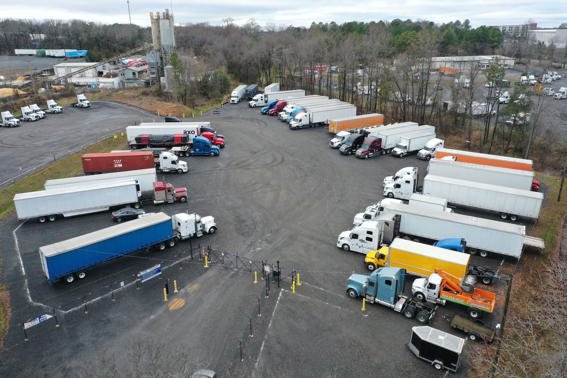 An aerial view of a lot of trucks parked in a parking lot.