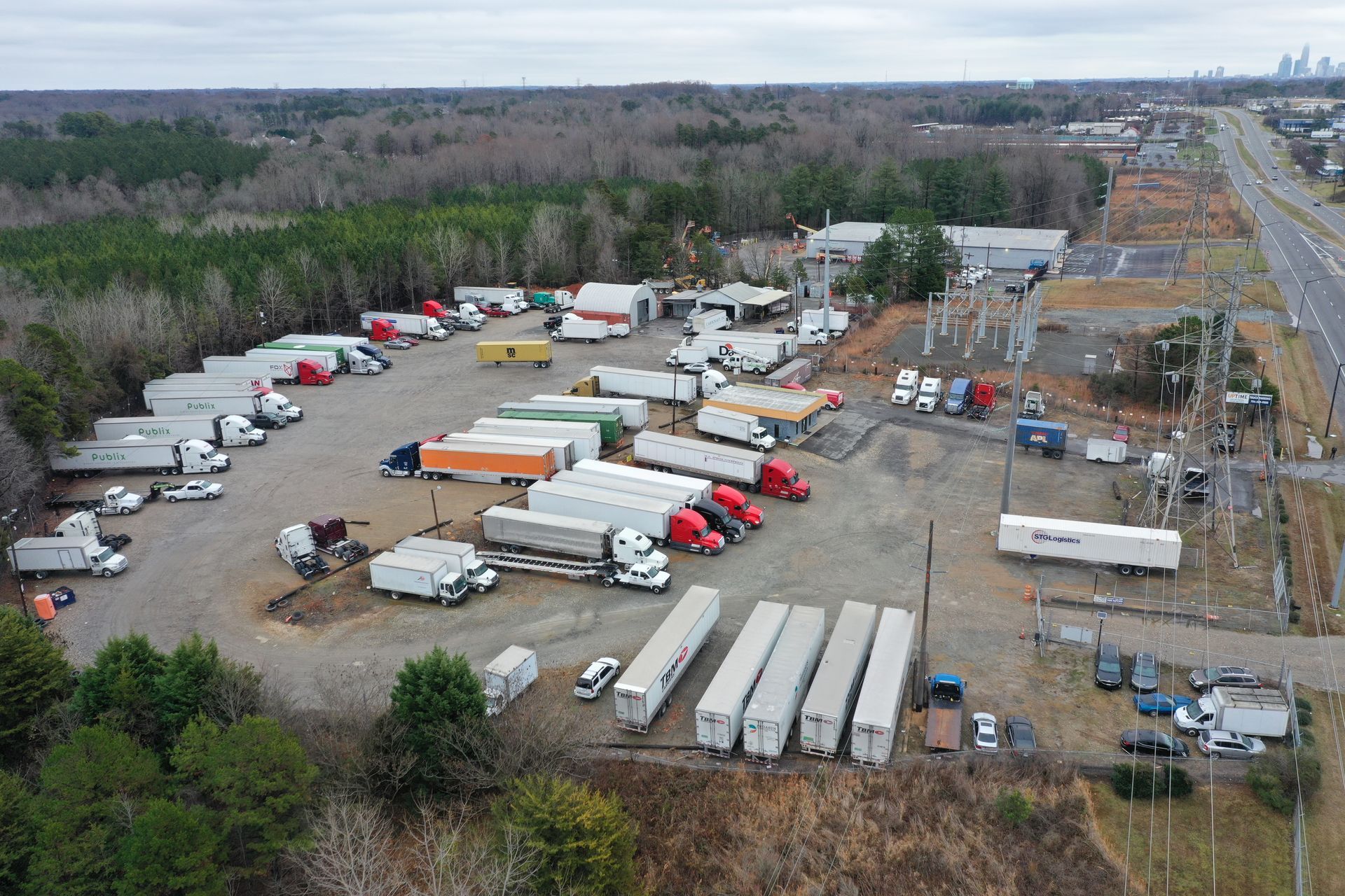 An aerial view of a parking lot filled with trucks and trailers.