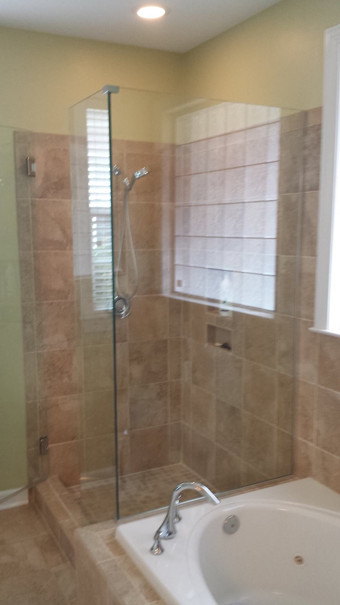 A bathroom with a walk in shower and a bathtub