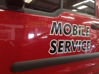 A red truck with mobile service written on the side
