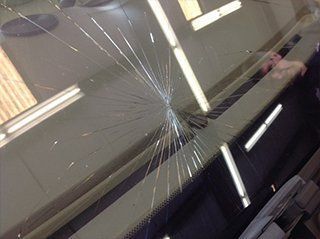 A close up of a broken windshield on a car