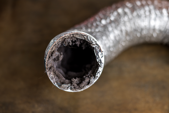 A close up of a rusty metal pipe on a table.