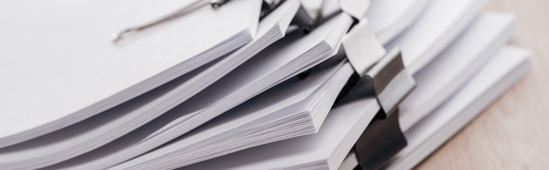 Bundle of white paper documents stacked on top of each other